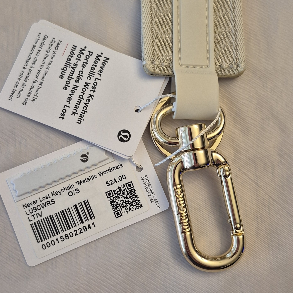 Lululemon Athletica Light Ivory Metallic Gold Wordmark Never Lost Keychain - Picture 4 of 4